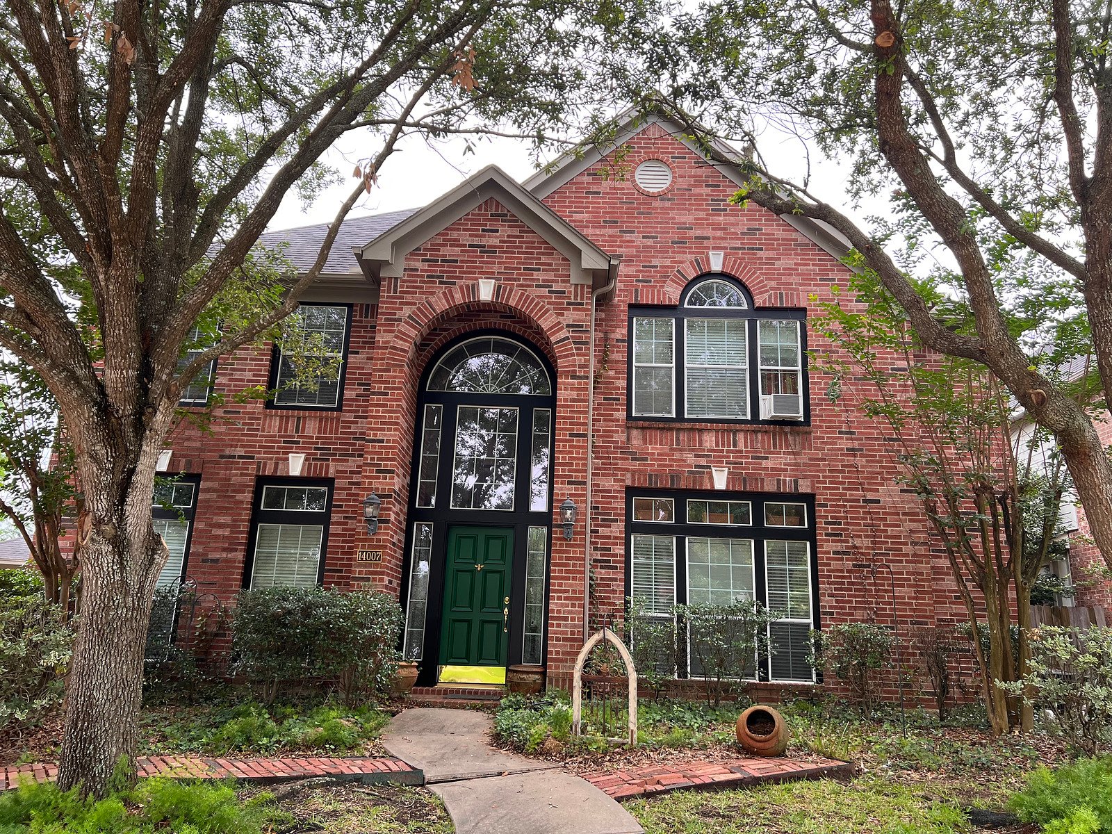 A red brick home with freshly painted accents and trim in Texas