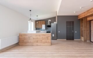 An open-plan kitchen with a gray accent wall