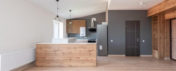 An open-plan kitchen with a gray accent wall