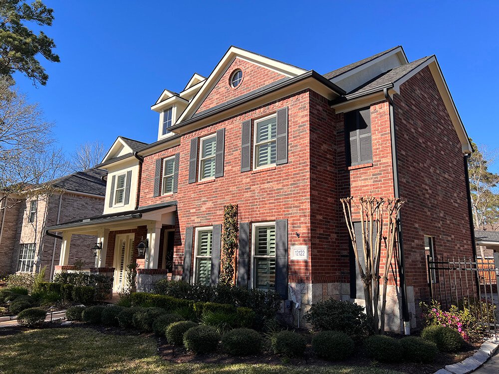 A well-kept brick house that has been professionally painted