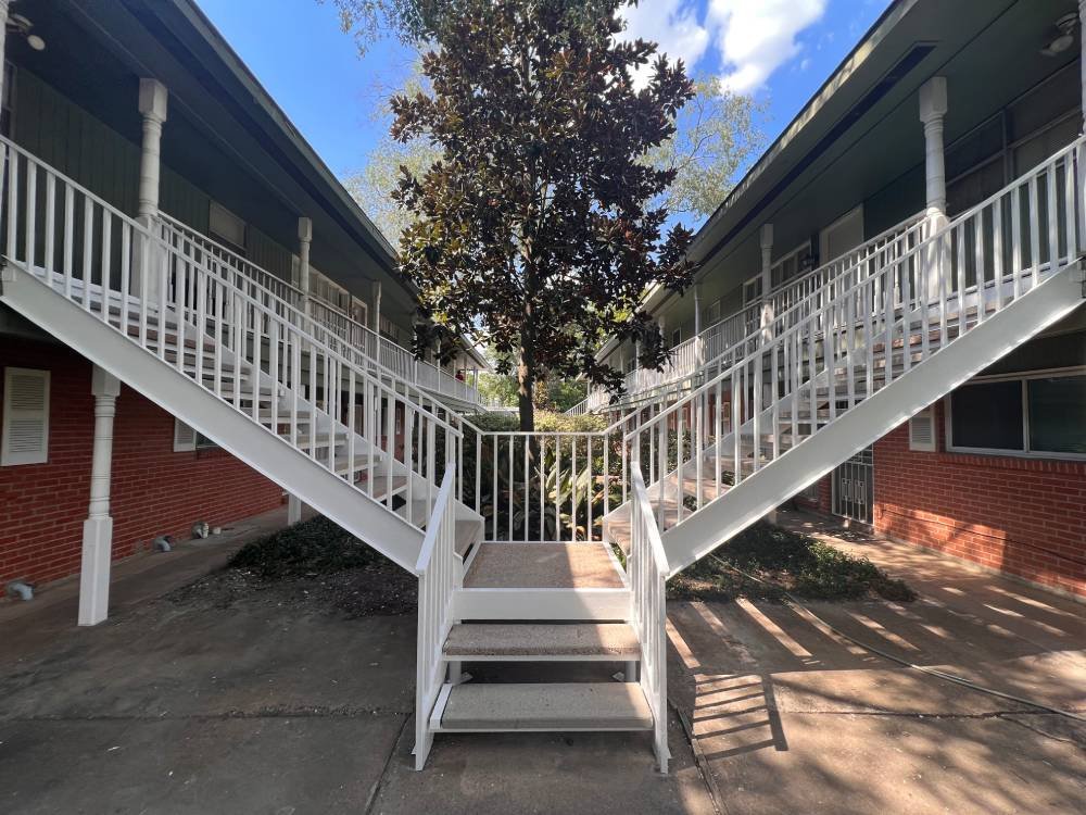 Outdoor staircases with white-painted wrought iron railings