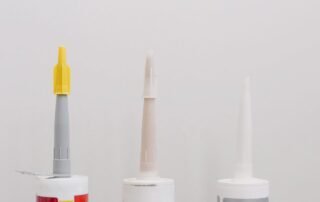 The tips of three caulking tubes