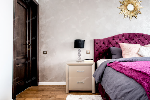 A bedroom with slightly purple-toned limewashed walls