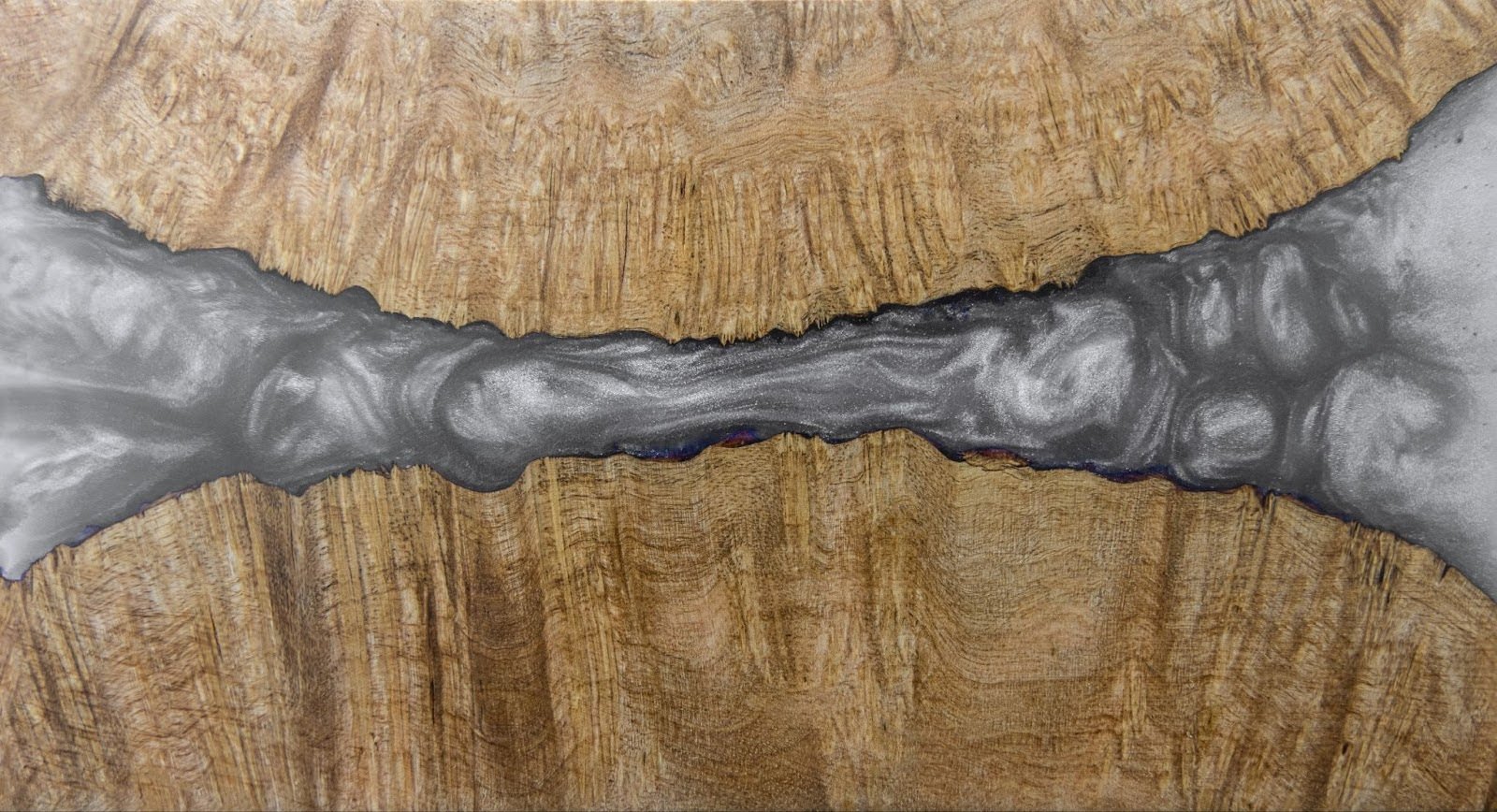 Metallic silver epoxy joining two areas of wood