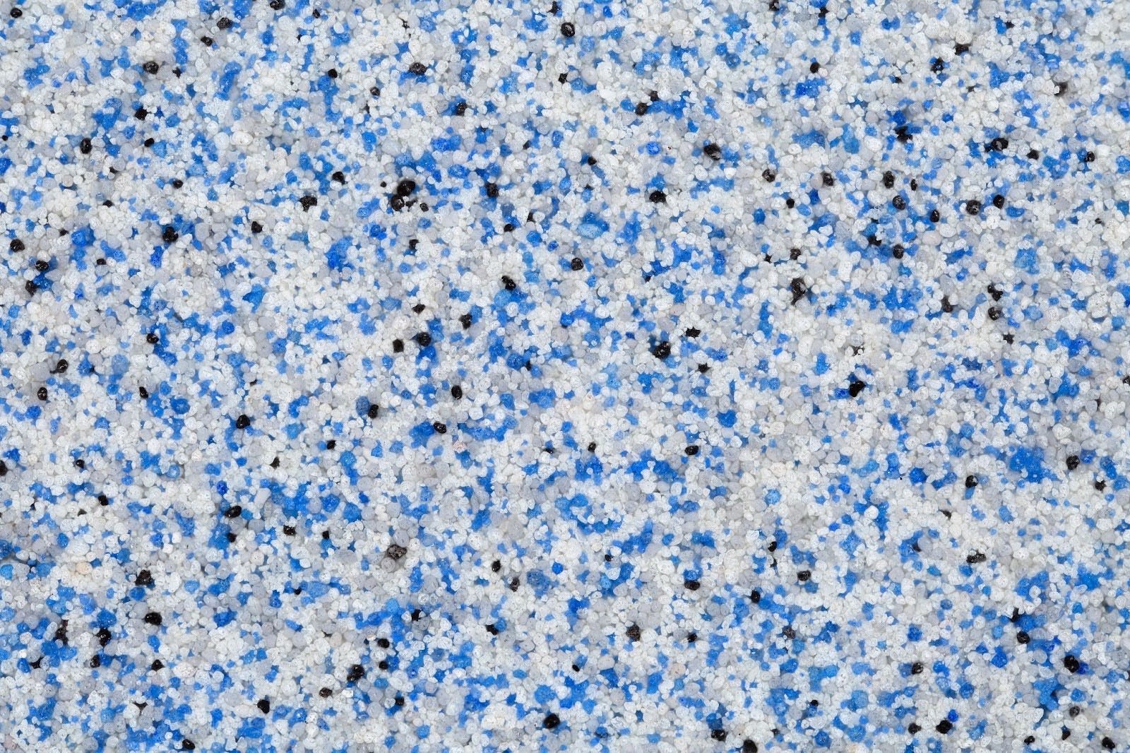 A decorative quartz sand epoxing floor finish with blue, grey, white and black colored particles