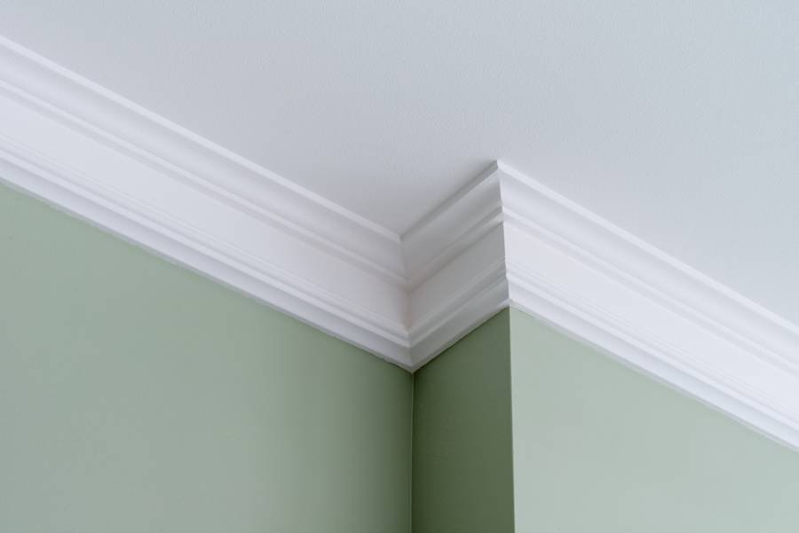 White ceiling crown molding on soft green interior walls