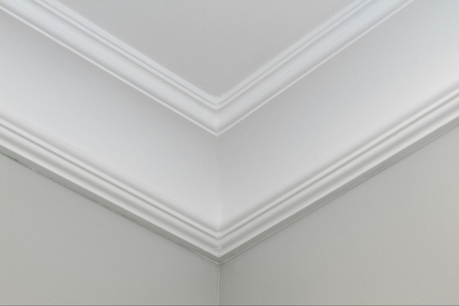 custom-crown-molding-corner Close-up of detailed white crown molding on ceiling corner