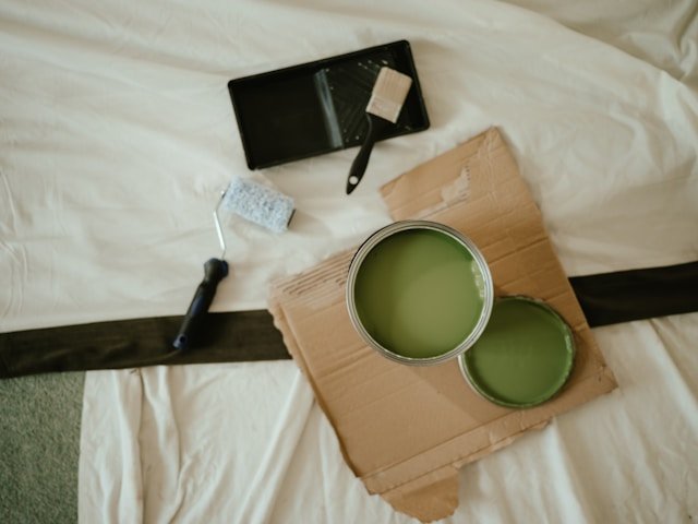 green-paint-tools-before-move-in Green paint and painting tools set out before project
