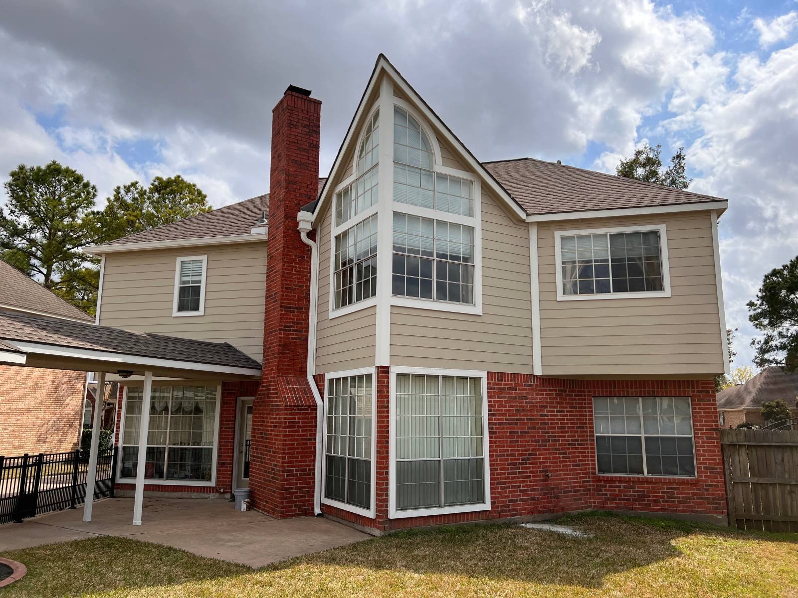 home-painters-midtown An angular multi-story brick and siding home in Houston