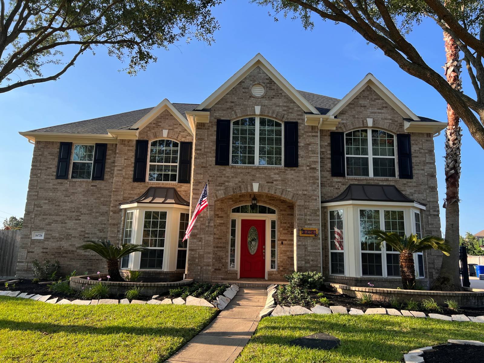 home-painting-museum-district A sophisticated Houston home contrasting brick and trim and a red painted door