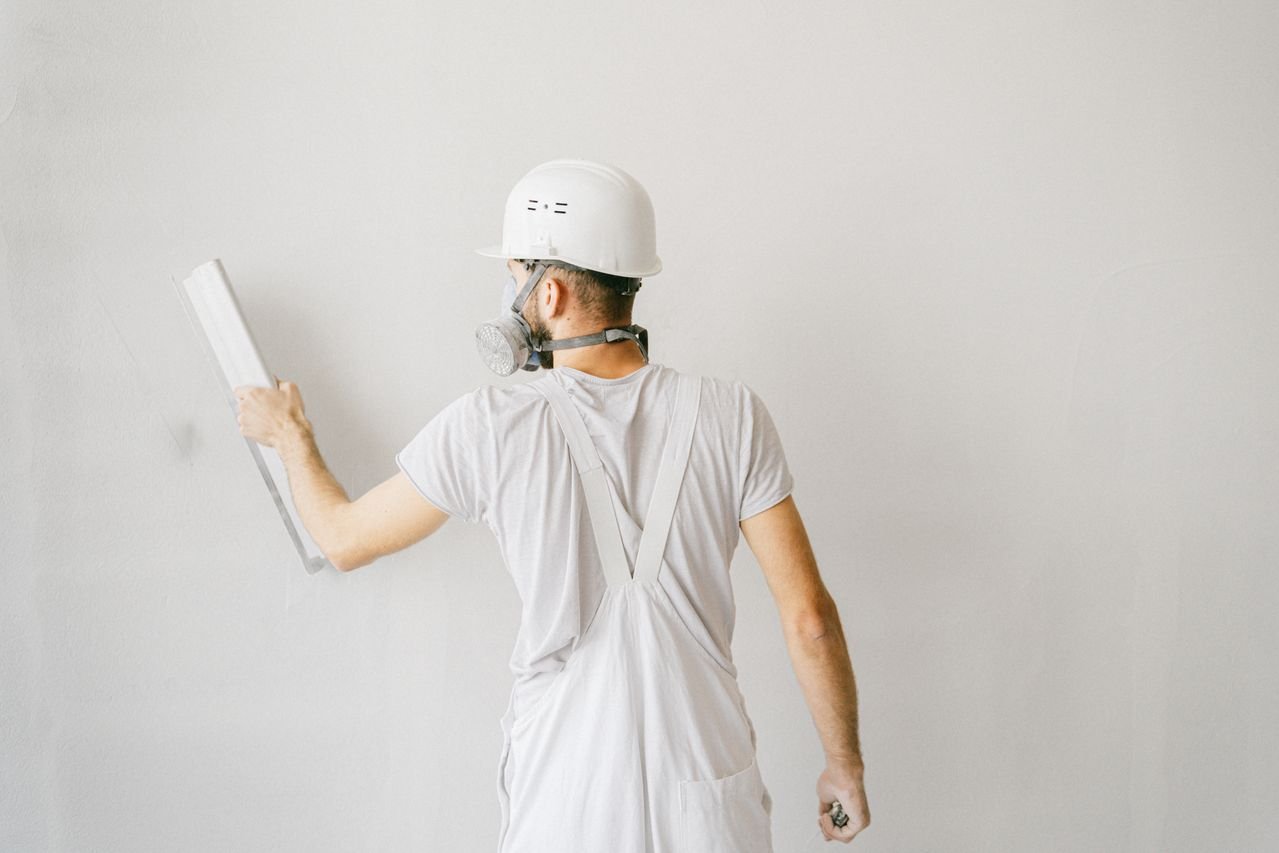 painter-smoothing-drywall Painter smoothing drywall before interior paint