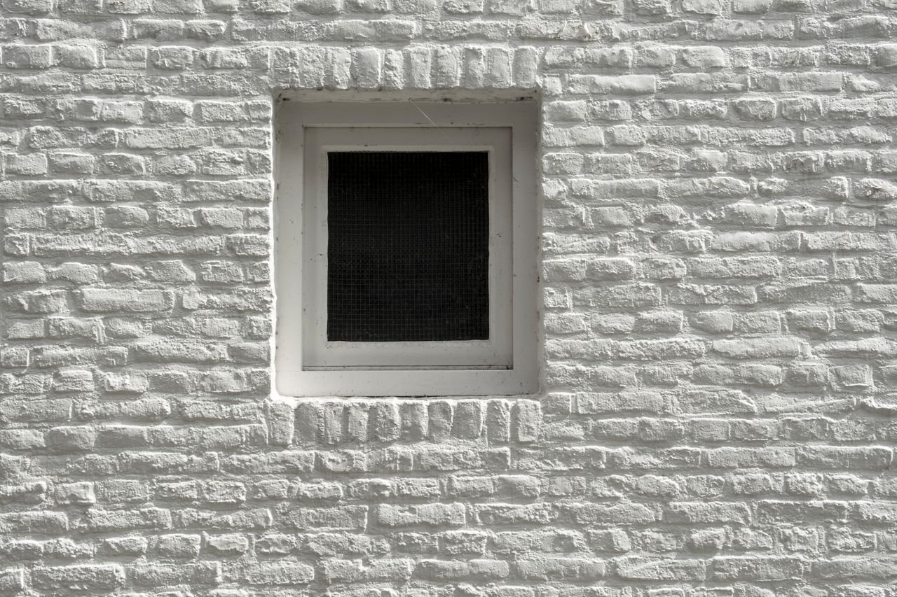 textured-white-brick-small-window Close-up of white brick exterior with a single, small window