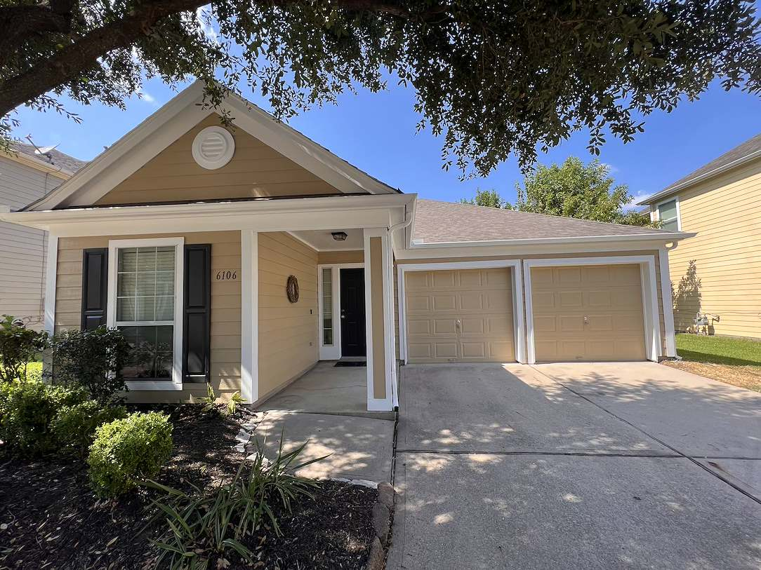 home-painters-magnolia A freshly painted beige home exterior with white trim